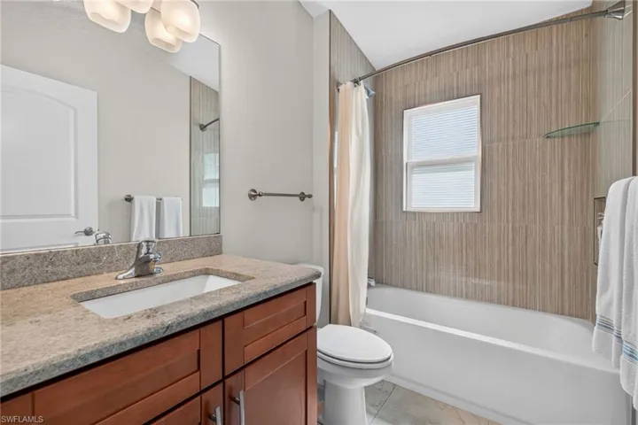 Bathroom featuring a vanity with a light-toned countertop and wood-finish cabinetry