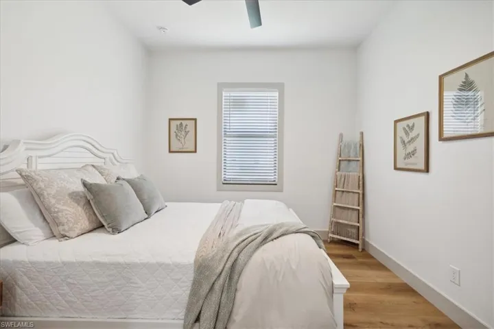 Bedroom featuring ceiling fan and hardwood / wood-style floors