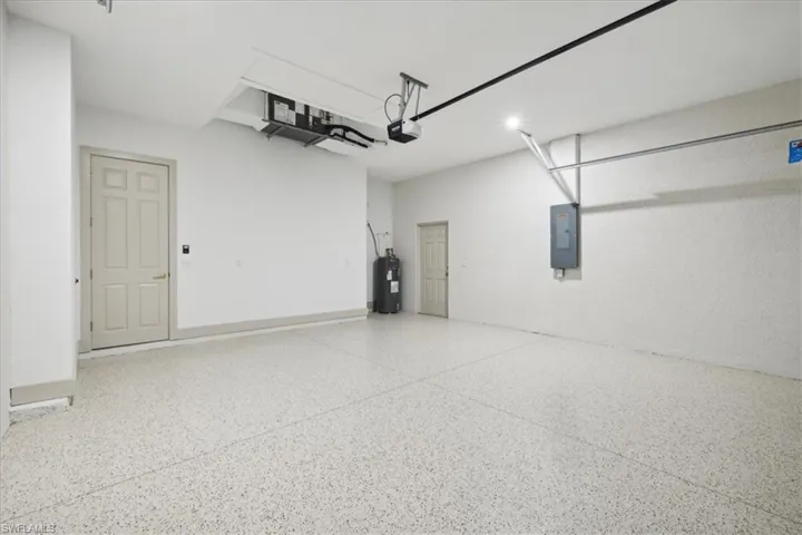 Garage with water heater and a garage door opener