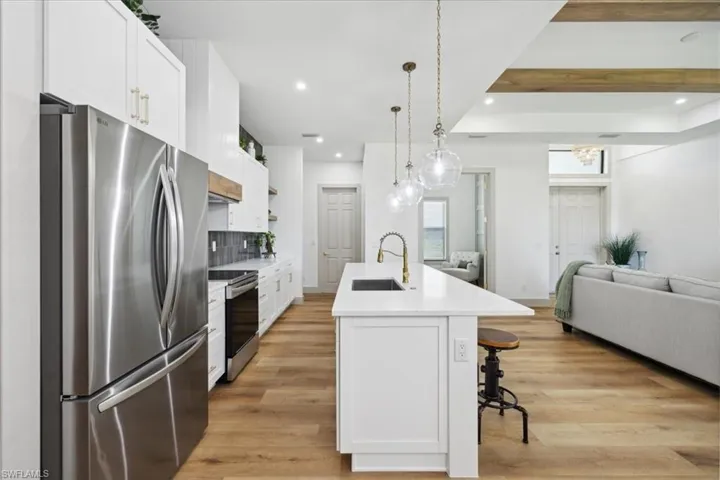 Kitchen featuring white cabinets, appliances with stainless steel finishes, sink, and light hardwood / wood-style floors