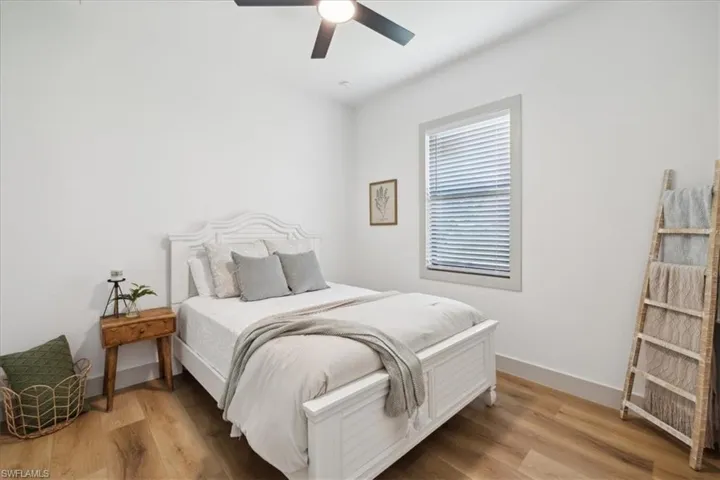 Bedroom with ceiling fan and hardwood / wood-style floors