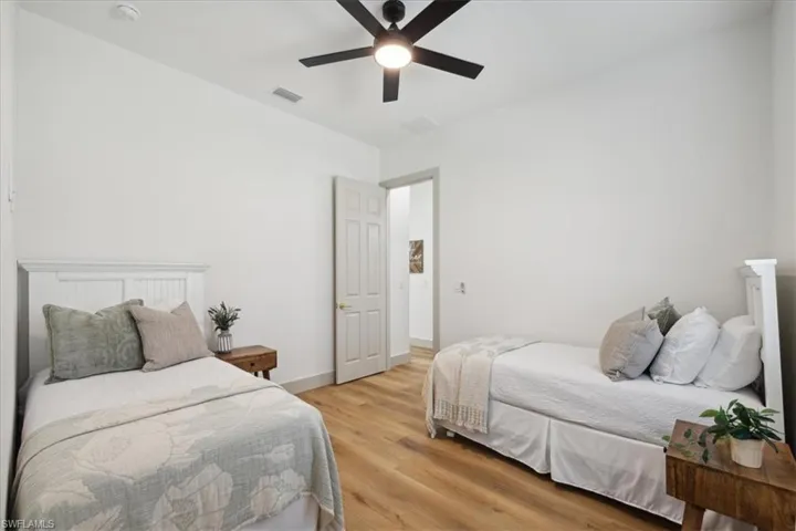 Bedroom with ceiling fan and light hardwood / wood-style floors