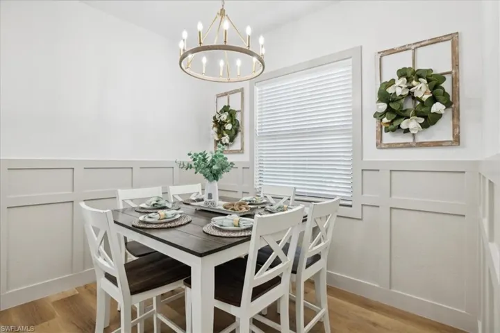 Dining area with a notable chandelier and light hardwood / wood-style floors
