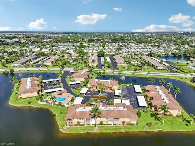Aerial perspective of suburban area featuring a large body of water