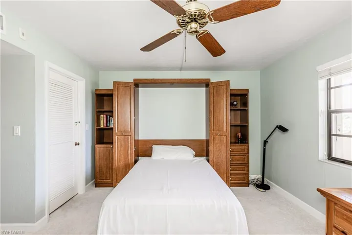 Bedroom with light colored carpet and ceiling fan