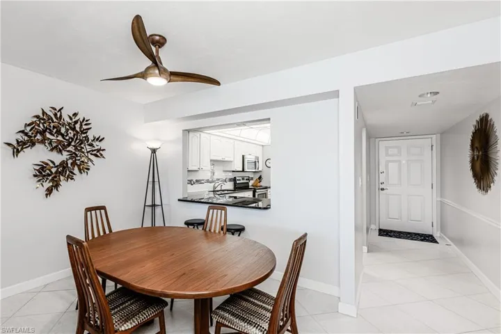 Dining area featuring light tile patterned floors and ceiling fan