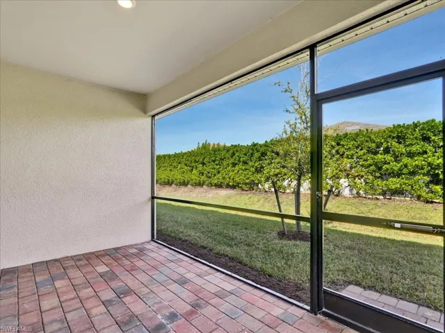 Unfurnished sunroom featuring agricultural plots, plenty of natural light, and a view of rural / pastoral area