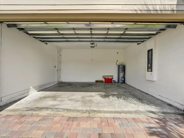 Garage with concrete block wall and electric water heater