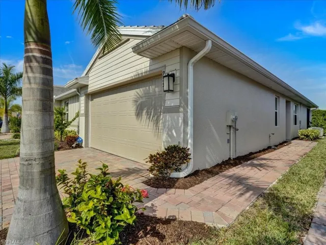 View of property exterior with stucco siding and a garage