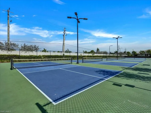 View of tennis court with community basketball court
