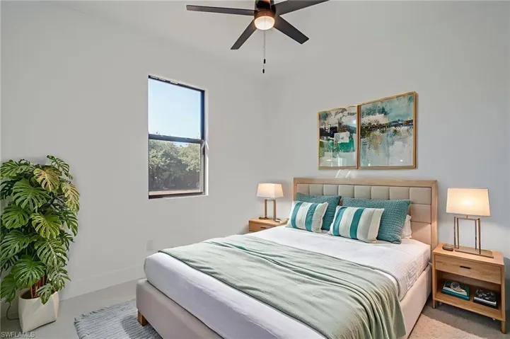 Bedroom featuring a ceiling fan and baseboards