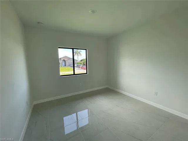 Spare room with light tile patterned floors