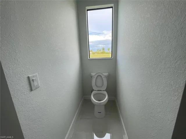 Bathroom featuring tile patterned floors and toilet