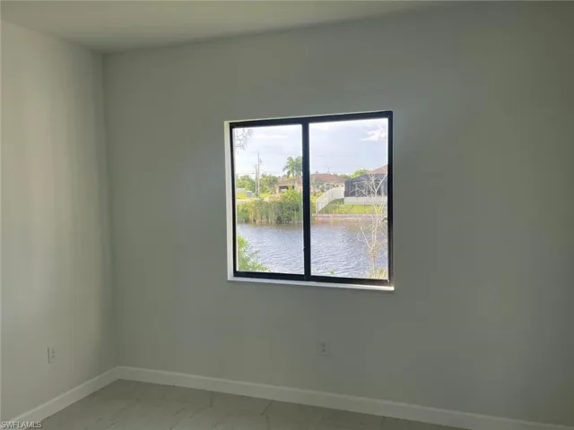 Unfurnished room with a water view