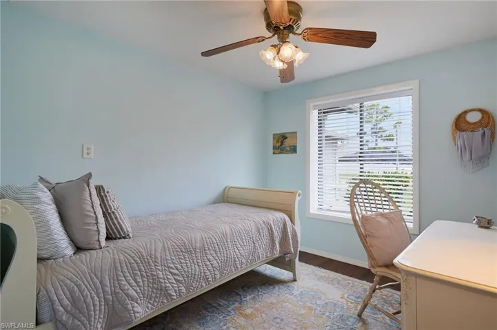 Bedroom with wood finished floors and ceiling fan
