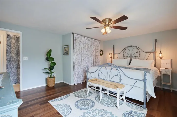 Bedroom featuring wood finished floors and a ceiling fan