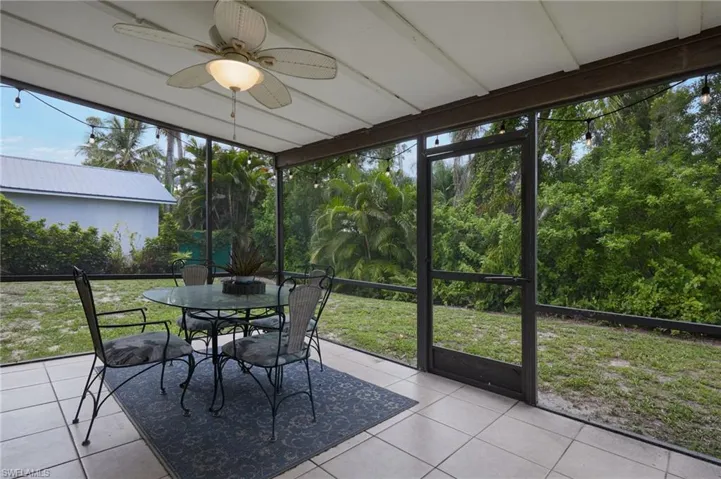 Sunroom with ceiling fan, outdoor dining space, and healthy amount of natural light