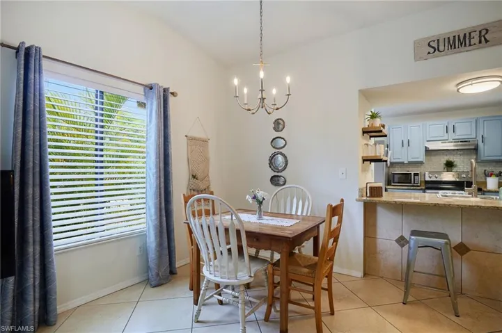 Dining room featuring a chandelier and light tile patterned floors