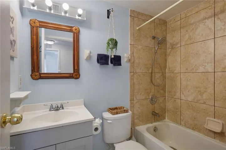 Full bath featuring vanity and shower / washtub combination
