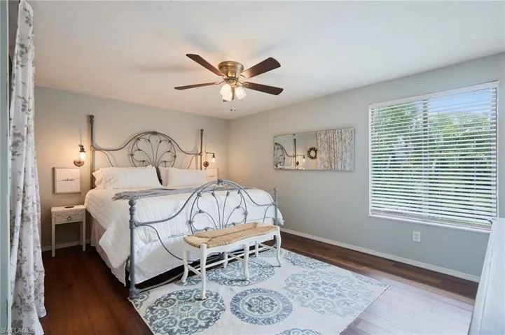 Bedroom with wood finished floors and ceiling fan