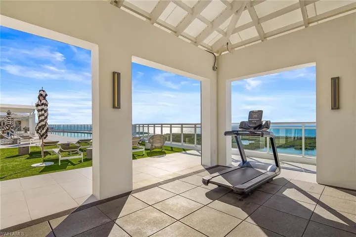 Stay energized in the open-air rooftop fitness space, framed by inspiring coastal views