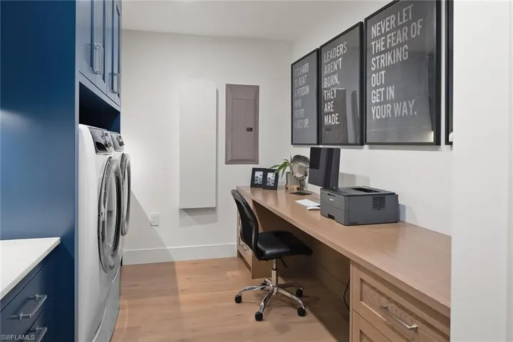 Spacious laundry room with a custom built-in desk, perfectly doubling as a home office