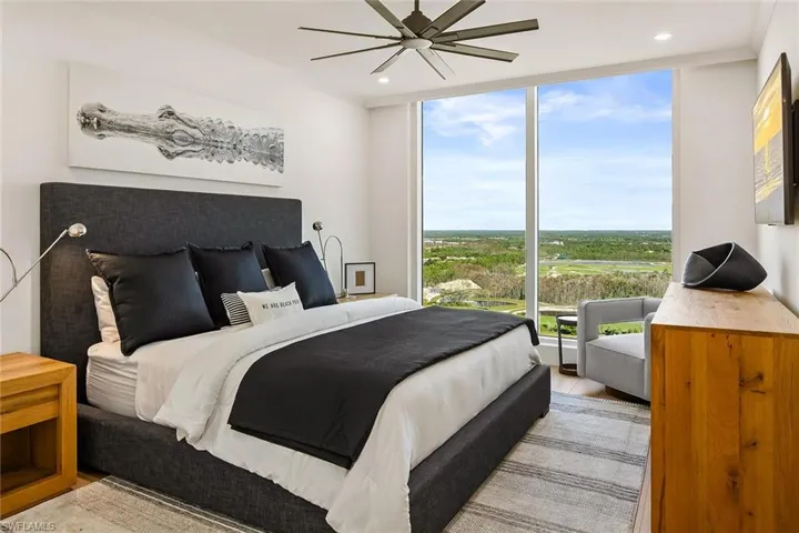 Furnished king-size guest suite featuring floor-to-ceiling windows and serene Kinsale golf views.