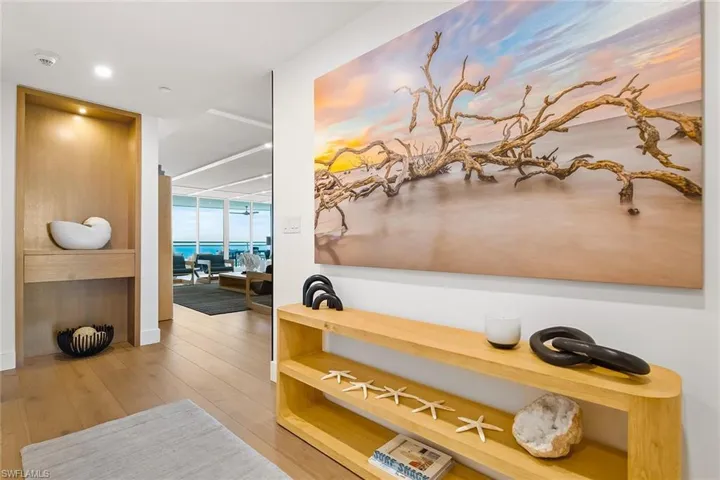 Private elevator access opens directly into the foyer, creating a refined arrival experience with gallery art, designer built in, and an immediate sense of privacy and exclusivity