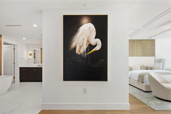 Entry foyer into the primary suite, highlighted by striking Dennis Goodman art -All furnishings, decor' and artwork are included.