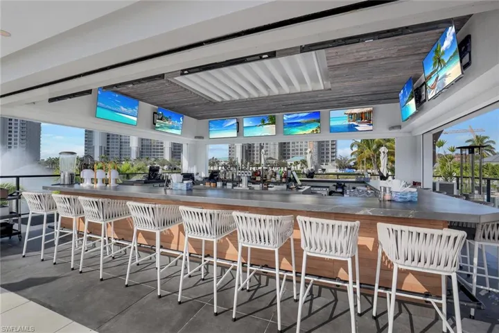 Open-air tiki bar where residents gather to watch the game, enjoy a drink, share a meal, and relax