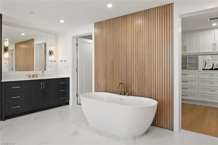 Freestanding Soaking Tub with Wood Accent Wall