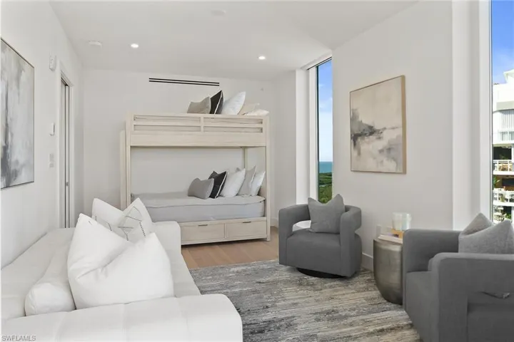 Versatile end-unit den with bunk beds and floor-to-ceiling windows overlooking the Gulf of Mexico