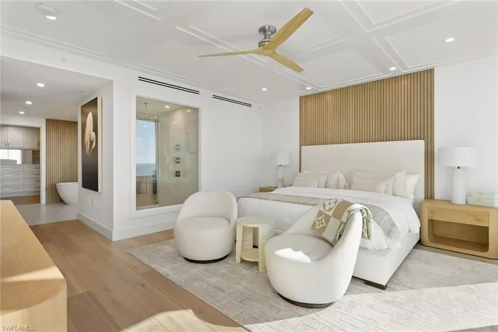 Serene primary ensuite retreat features a glass shower window, opening the shower to the view