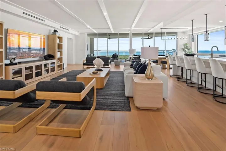 Open living featuring custom RH furnishings, wood ceiling detailing, and hardwood floors throuhout