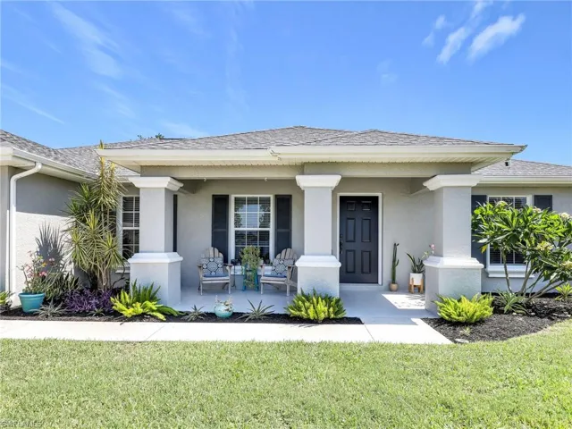 View of front of property featuring a front yard and a porch