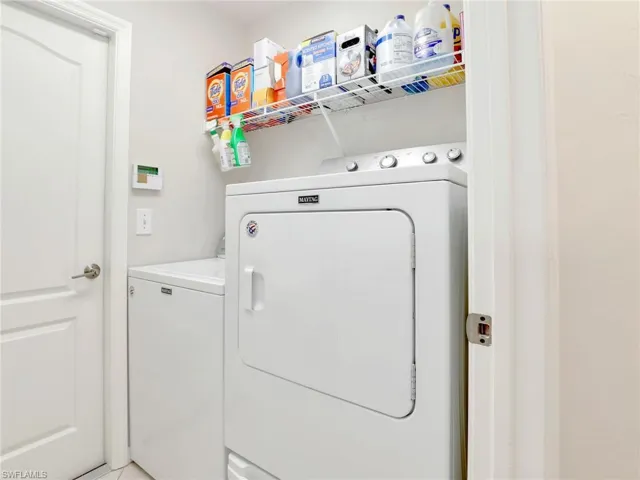 Washroom with washing machine and clothes dryer