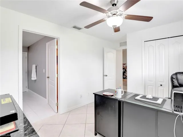 Office featuring ceiling fan and light tile floors