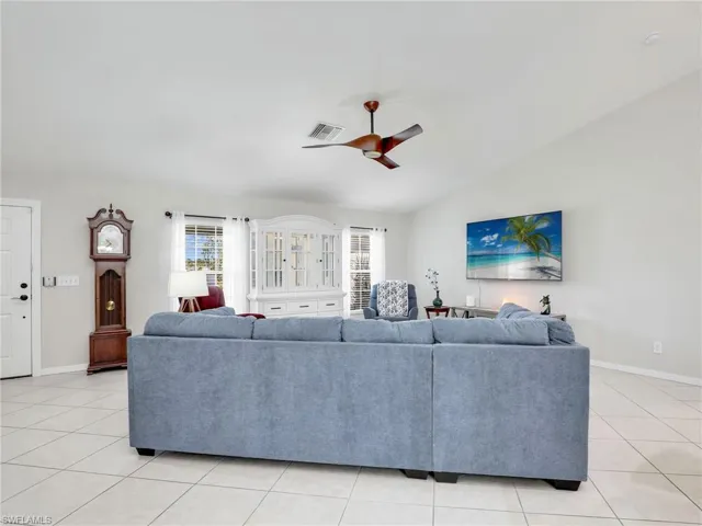 Tiled living room featuring ceiling fan