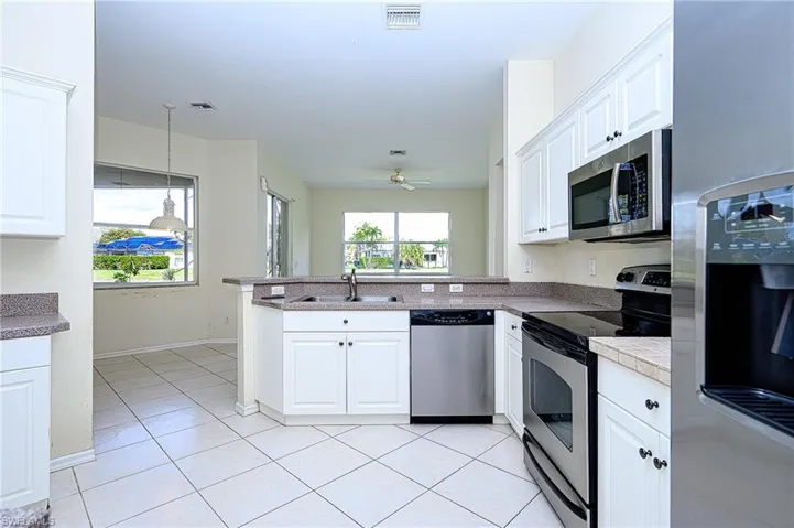 Kitchen with white cabinets and stainless steel appliances
