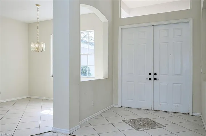 Entryway with light tile patterned floors!