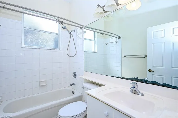 Full bath with shower / bath combination, vanity, and toilet