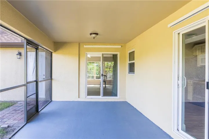 View of patio featuring a sunroom