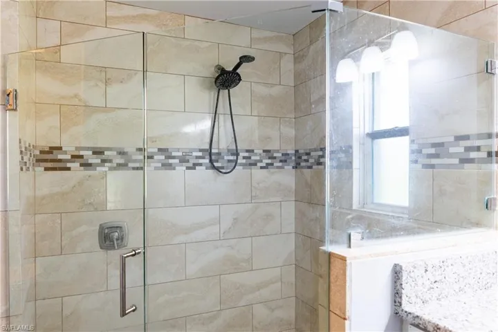 Full bathroom with a shower stall