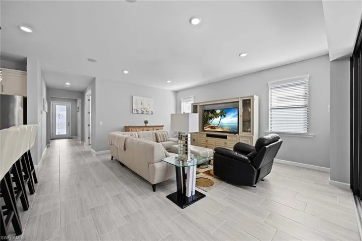 Living area with healthy amount of natural light and recessed lighting