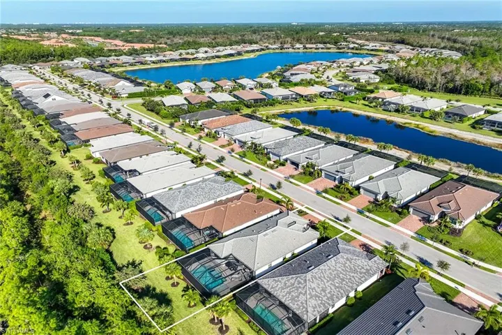 Aerial perspective of suburban area featuring a large body of water