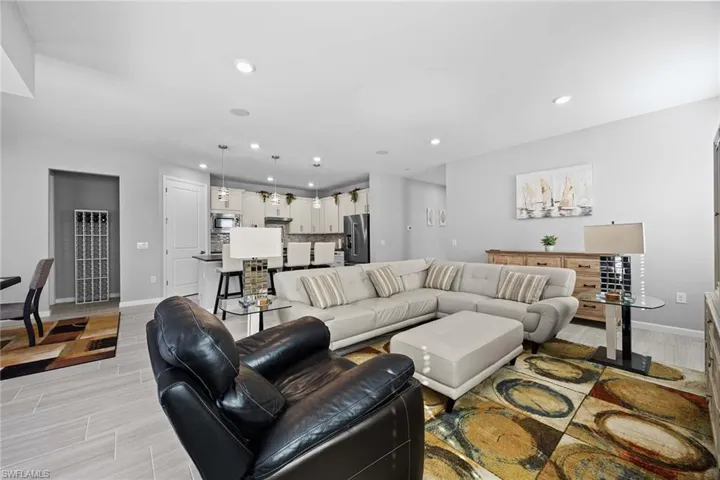 Living room featuring a heating unit, recessed lighting, and wood finish floors
