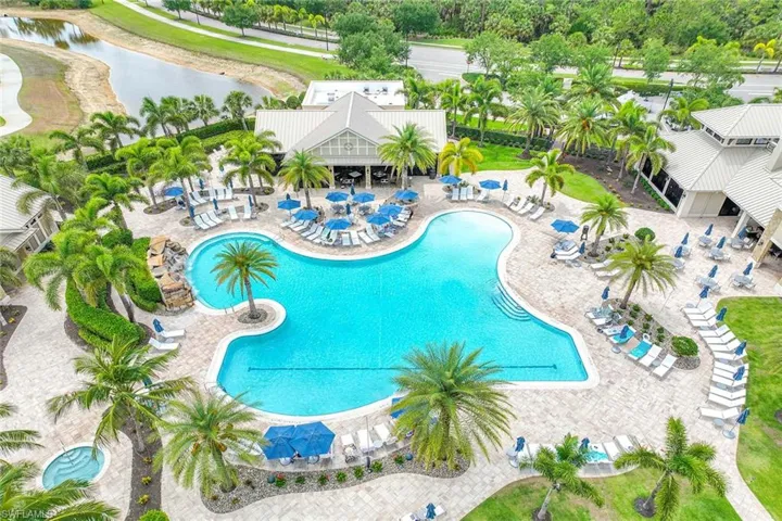 Community pool featuring a patio and a water view