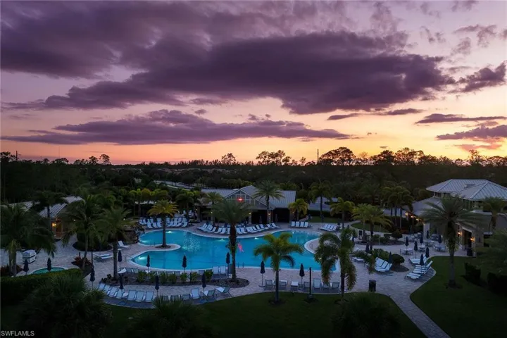 Pool at dusk with a community pool and a patio area