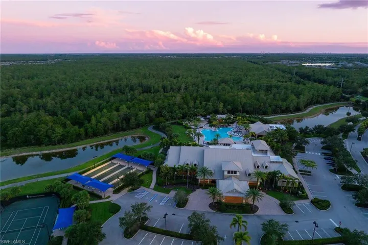 Aerial view at dusk of a water view and a wooded view