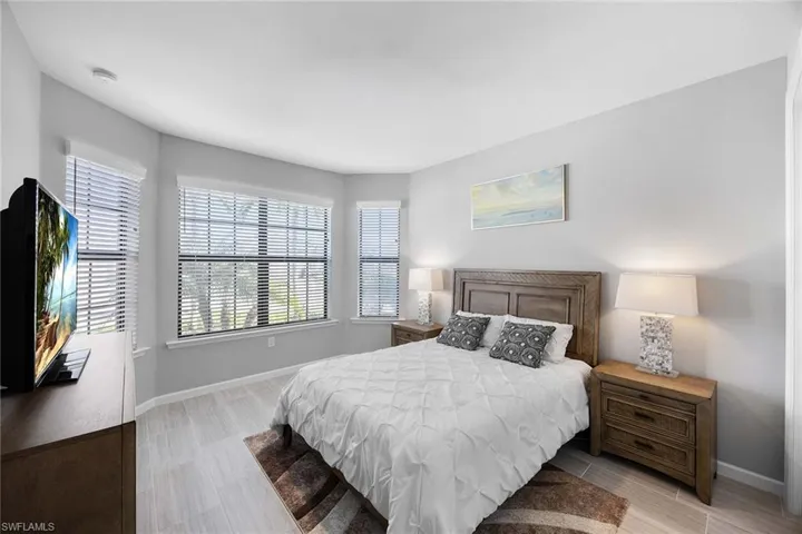 Bedroom with baseboards and wood finish floors